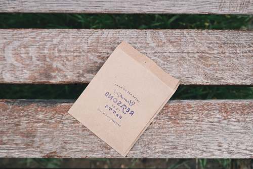 flat lay brown printing paper on brown wooden bench flatlay
